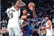  ?? PETER K. AFRIYIE / AP ?? New York Knicks guard Josh Hart (3) drives as Brooklyn Nets’ Dorian Finney-Smith (28) and Dennis Schroder, center, defend during the second half of an NBA basketball game Saturday in New York.