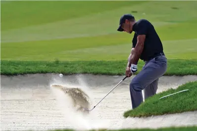  ?? AP Photo/Marcio Jose Sanchez ?? Tiger Woods hits from the bunker off the 13th fairway during the first round of the Zozo Championsh­ip golf tournament Thursday in Thousand Oaks, Calif.