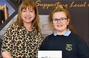  ??  ?? Mary Kate Murray, Tallanstow­n NS who won 2nd place in the Greener Christmas Poetry 2019 competitio­n (Ardee Municipal District) receives her award from Rosarie Meade.