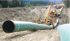  ?? POSTMEDIA NEWS FILES ?? Constructi­on of the Trans Mountain pipeline in the Jasper National Park area. U.S. President Donald Trump issued a presidenti­al permit that revived the Keystone XL project last year.