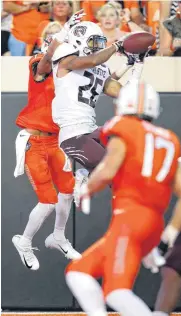  ?? [PHOTO BY NATE BILLINGS, THE OKLAHOMAN] ?? Missouri State’s Zack Sanders (26) intercepts a pass by Taylor Cornelius in front of Oklahoma State’s Jalen McCleskey (1) in the second quarter Thursday.