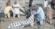  ??  ?? Officials cover a body after the blast in Quetta.