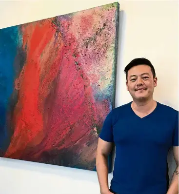  ?? — MAJORIE CHIEW / The Star ?? ‘This first solo show allows me to show the progressio­n of my journey in art,’ says Low, standing next to his work Lick Of Fire Earth (Fluid 2) .
