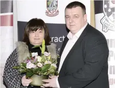  ??  ?? Keith Gilroy presents Mrs Angela Niland, mother of Lisa, with a bunch of flowers.