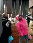  ?? PHOTO: AP ?? Kim McRae and Melodi McNeil look at commemorat­ive markers listing lynching victims yesterday at the National Memorial for Peace and Justice in Montgomery, Alabama.