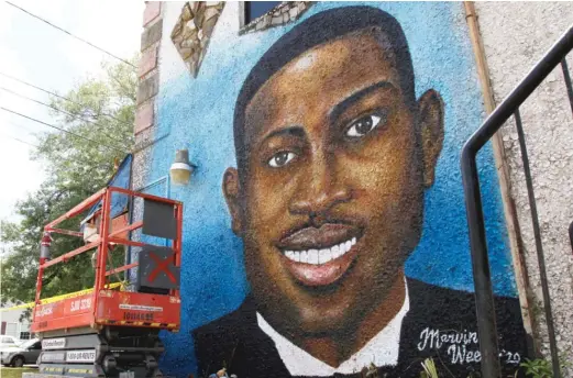  ?? SARAH BLAKE MORGAN/AP ?? In this May 17, 2020, file photo, a recently painted mural of Ahmaud Arbery is on display in Brunswick, Georgia, where the 25-year-old man was shot and killed in February. Three men are on trial for Arbery’s murder.