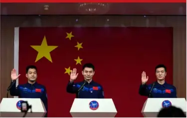  ?? ?? Astronauts for the upcoming Shenzhou-18 mission, from left, Li Guangsu, Ye Guangfu and Li Cong wave as they arrive for a meeting with the press at the Jiuquan Satellite Launch Center, yesterday