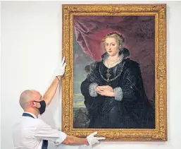  ?? Picture: PA. ?? A Sotheby’s technician with the rediscover­ed Rubens portrait, dated to circa 1625.
