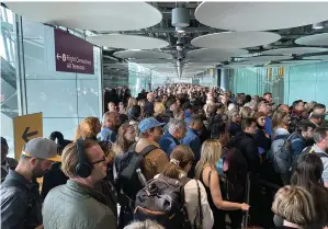  ?? — ap ?? Queues like this at Heathrow airport arrivals were also seen across other airports in the UK on Saturday after a technical problem shut electronic border gates, forcing everyone to have their passports checked manually.