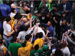  ?? ?? The Warriors' Stephen Curry signs autographs for fans crowding around him before the start of Game 6of the NBA Finals at TD Garden in Boston.