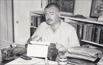  ?? Ernest Hemingway Collection / John F. Kennedy Presidenti­al Library ?? Ernest Hemingway sits at his typewriter, writing, at Finca Vigia, near San Francisco de Paula, Cuba, in Ken Burns’ new series, “Hemmingway,” airing at 8 p.m. on PBS.