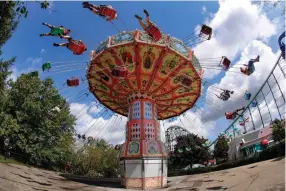  ?? Associated Press ?? ■ Visitors ride the Wave Swinger on Aug. 29 at Kennywood Park in West Mifflin, Pa.