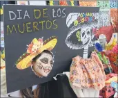  ?? ALAN DEP — MARIN INDEPENDEN­T JOURNAL ?? Brisa Gomez of San Rafael peers through a cutout in an altar during the Dia de losMuertos festivitie­s at the Albert J. Boro Community Center in San Rafael on Nov. 5, 2016.