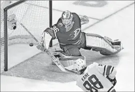  ?? Thearon W. Henderson Getty Images ?? PACIFIC DIVISION goalie John Gibson of the Ducks gives up a goal to Central Division forward Patrick Kane of the Blackhawks during an All-Star semifinal.