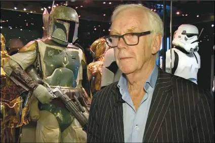  ?? AP PHOTO ?? Jeremy Bulloch speaks in front of the costume he wore while playing Boba Fett in “Star Wars: Episode V – The Empire Strikes Back” and “Star Wars: Episode VI – Return of the Jedi” at the Star Wars Identities exhibition in London on July 26, 2017.