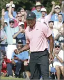  ?? Atlanta Journal-Constituti­on via AP CURTIS COMPTON photo ?? Tiger Woods and the gallery react as he sinks his eagle putt on the 18th green Thursday.