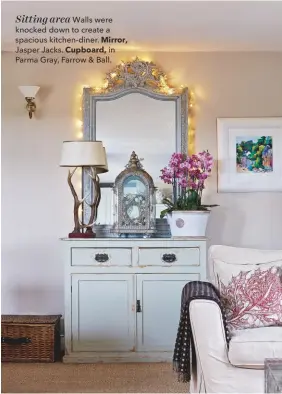  ??  ?? Sitting area Walls were knocked down to create a spacious kitchen-diner. Mirror, Jasper Jacks. Cupboard, in Parma Gray, Farrow &amp; Ball.