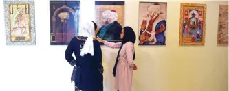  ??  ?? Visitors walk past a display of Mughal paintings at the ‘King Babur’s Kabul, Cradle of the Mughal Empire’ exhibition at the Bagh-e-Babur Garden in Kabul. — AFP photos