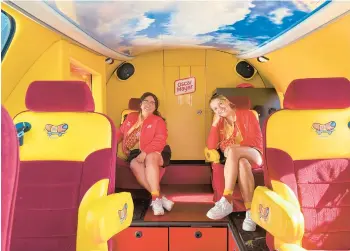  ?? JULIA CARMEL/LOS ANGELES TIMES ?? Hotdoggers Keila Garza, left, and Abbey Rank sit in their Oscar Mayer Wienermobi­le as they take a break from driving it around Los Angeles.