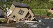  ?? DAVID GOLDMAN / ASSOCIATED PRESS ?? A house sits in Rock Creek after floodwater­s washed away a road and a bridge Wednesday in Red Lodge, Mont.