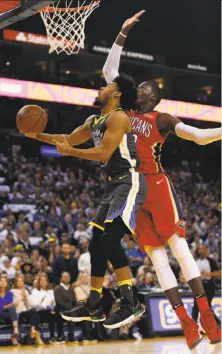  ?? Santiago Mejia / The Chronicle ?? Warriors guard Quinn Cook (left) gets his shot blocked by Pelicans forward Cheick Diallo but did score 21 points.