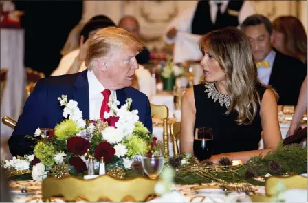  ?? ANDREW HARNIK — THE ASSOCIATED PRESS ?? President Donald Trump and first lady Melania Trump talk at Mar-a-lago while there for Christmas Eve dinner in Palm Beach, Fla., Tuesday.