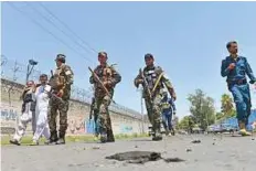  ?? AP ?? Troops arrive at the site of a separate suicide attack in the city of Jalalabad.