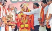  ?? PTI ?? ▪ Chief minister Yogi Adityanath being garlanded by V Somanna as BJP state unit president B S Yeddyurapp­a looks on, during the BJP Parivartan Rally in Bengaluru on Sunday.