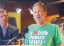  ?? DEAN HANSON/JOURNAL ?? U.S. Sen. Martin Heinrich, left, listens as REI Director of Community and Government Affairs Marc Berejka express his support for federally protected wild spaces in the state and nation during a rally at REI on Thursday afternoon.