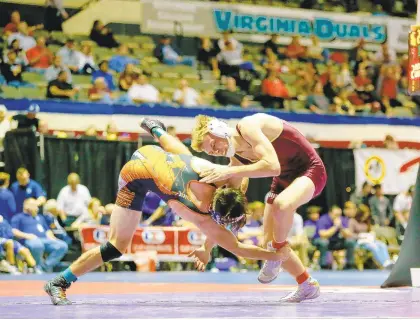  ?? JOHN SUDBRINK/FOR THE DAILY PRESS ?? Poquoson 152-pounder Jake Williams, right, wrestles Coby Cheatham of Powhatan during the first day of the 39th annual Virginia Duals at Hampton Coliseum. Cheatham won 6-2. The Islanders built a sizable lead but were overtaken by the Indians at the heavier weights, losing 36-33.