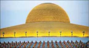  ?? ROBERTO SCHMIDT/AFP ?? Buddhist monks sit in rows during evening prayers to mark Makha Bucha Day at Wat Phra Dhammakaya temple, near Bangkok, on March 1.