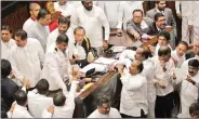  ?? IANS ?? Legislator­s of the Sri Lankan parliament gather in front of Speaker Karu Jayasuriya at a session, in Colombo, Sri Lanka, on Thursday.