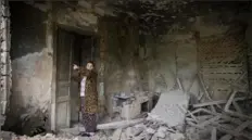  ?? Efrem Lukatsky/Associated Press ?? Local resident Tetyana shows where the Russian shells came from and heavily damaged her house in Bakhmut, Donetsk region, Ukraine, on Friday.