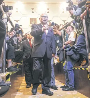  ?? EPA-EFE ?? Chairman of the Malaysia Election Commission (MEC) Mohd Hashim Abdullah, centre, arrives for a press conference at the MEC headquarte­rs in Putrajaya, Malaysia.