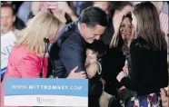  ?? Jessica Rinaldi, Reuters ?? GOP presidenti­al candidate Mitt Romney hugs his family after speaking at his Super Tuesday primary rally in Boston.