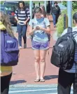  ?? THE (WILMINGTON, DEL.) NEWS JOURNAL ?? A phone-focused pedestrian prepares to cross the street.