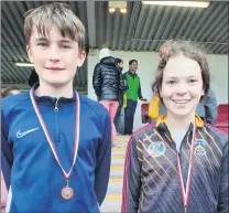  ?? ?? U14 Fionn Hayes who won gold in 2k race walking with U13 Emilie McElvaneyw­ho received 2nd place javelin.