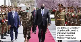  ??  ?? US defence secretary Lloyd Austin, centre, walks with acting Afghan defence minister Yasin Zia