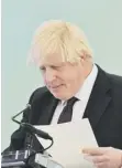  ?? ?? ↑ Boris Johnson shuffling his papers