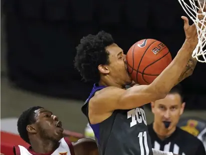  ?? AP ?? SMASHMOUTH BASKETBALL: TCU guard Taryn Todd loses control of the ball as he drives to the basket ahead of Iowa State guard Jalen Coleman-Lands Saturday in Ames, Iowa.