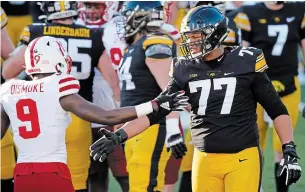  ?? CHARLIE NEIBERGALL THE ASSOCIATED PRESS FILE PHOTO ?? Iowa offensive lineman Alaric Jackson (77) continues to hold down the top spot on the Canadian Football League Scouting Bureau’s list of the top-20 prospects for this year’s draft.