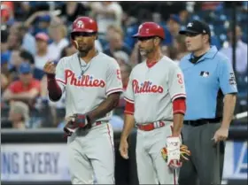  ?? FRANK FRANKLIN III — THE ASSOCIATED PRESS ?? Jose David Flores, right, next to Nick Williams, is more than just the Phillies’ first base coach. He’s also the baserunnin­g instructor and a big reasons the Phils are in playoff contention.