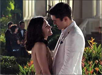  ??  ?? Rachel (Constance Wu) discovers her fiance, Nick (Henry Golding), comes from an incredibly wealthy family in Jon M. Chu’s Crazy Rich Asians, adapted from Kevin Kwan’s best-selling novel.