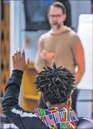  ??  ?? A student raises his hand during Presti's presentati­on at Star Spencer High School.