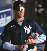  ?? CHARLIE NEIBERGALL/AP ?? The Yankees’ Juan Soto stands in the dugout before a spring training game against the Red Sox on March 13 in Tampa, Fla.