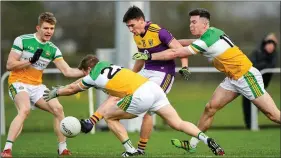 ??  ?? Wexford attacker Robbie Brooks under pressure from Offaly trio David Dempsey, Brian Darby and Conor McNamee.