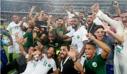  ?? AP ?? Saudi Arabia players celebrates after defeating Japan 1-0 to secure a World Cup berth. —