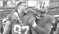  ?? Jose Carlos Fajardo
/ Bay Area News Group ?? San Francisco 49ers’ Nick Bosa (97) and Trent Williams (71) celebrate after defeating the New Orleans Saints at Levi’s Stadium in Santa Clara on Sunday.the San Francisco 49ers defeated the New Orleans Saints 13-0.