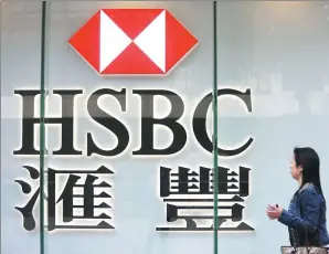  ?? PROVIDED TO CHINA DAILY ?? A pedestrian walks past a HSBC sign in Hong Kong.