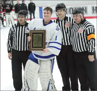  ?? Photo by Ernest A. Brown ?? Cumberland goalie Jack Byrne stands with the officials after being presented the Monsignor Robert C. Newbold Memorial Most Valuable Player Award. Byrne stopped all 21 shots he faced on Monday night as the Clippers skated away with the Division II title.
